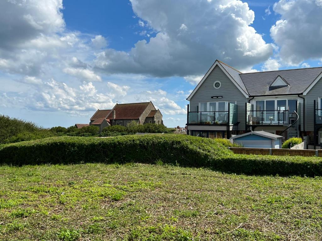 a house sitting on top of a grassy hill at The Lookout in Mundesley