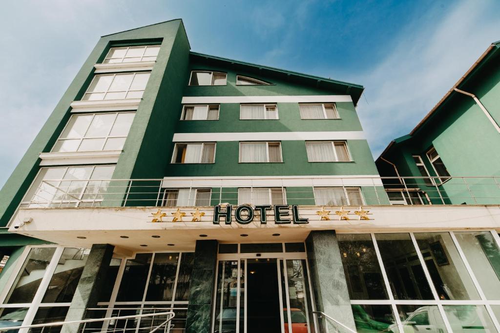 a hotel with a sign on the front of it at Hotel Atlantis in Tulcea