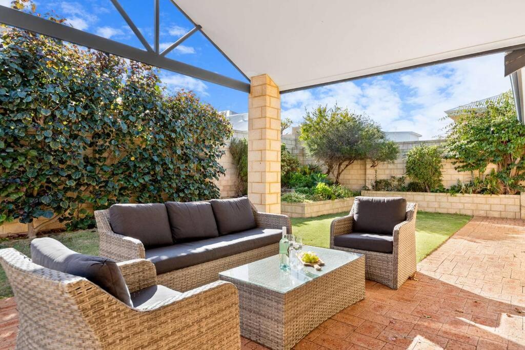 a patio with a couch and two chairs and a table at Avalon Beach Escape ~ Family Favourite with Wifi in Mandurah