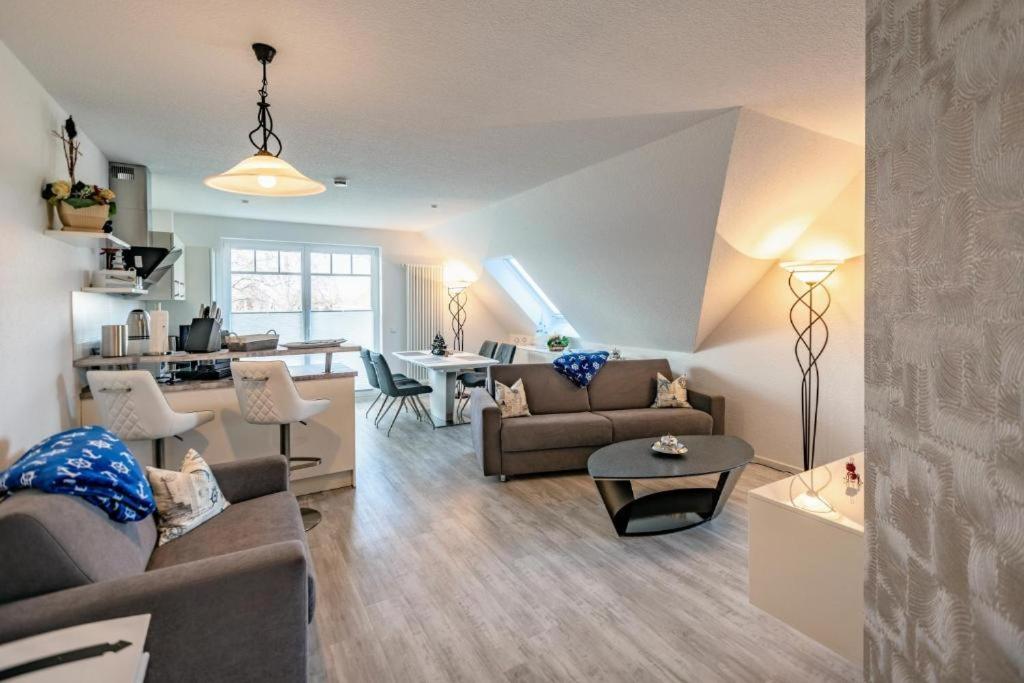 a living room with a couch and a table at Ostseeblick Apartmenthaus im Ostseebad Nienhagen in Ostseebad Nienhagen