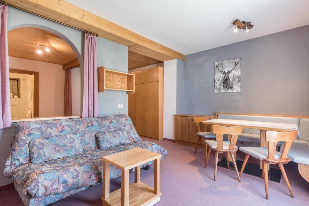 a living room with a couch and a table at Ferienparadies Sabina Euringer in Alpe di Siusi