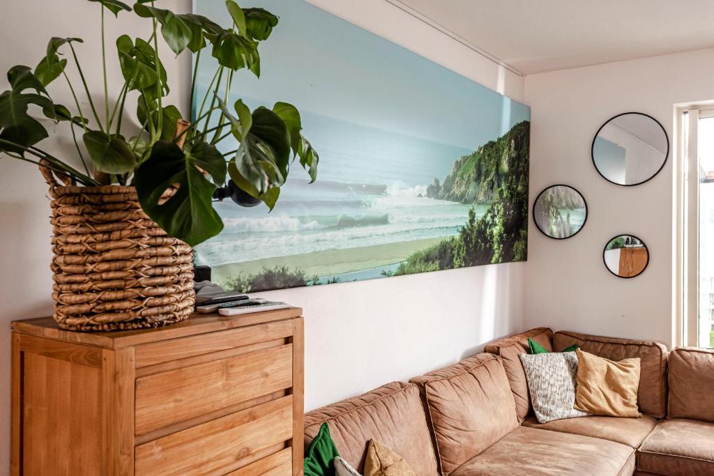 a living room with a couch and a painting on the wall at FamilyHome near the Ocean in Scheveningen