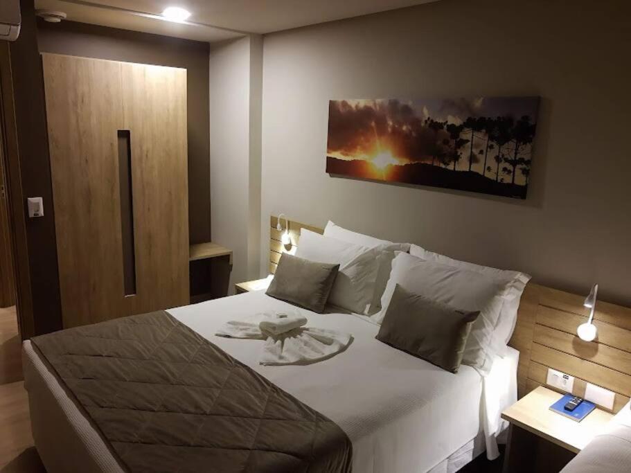 Postel nebo postele na pokoji v ubytování Gramado Golden - Infraestrutura Completa