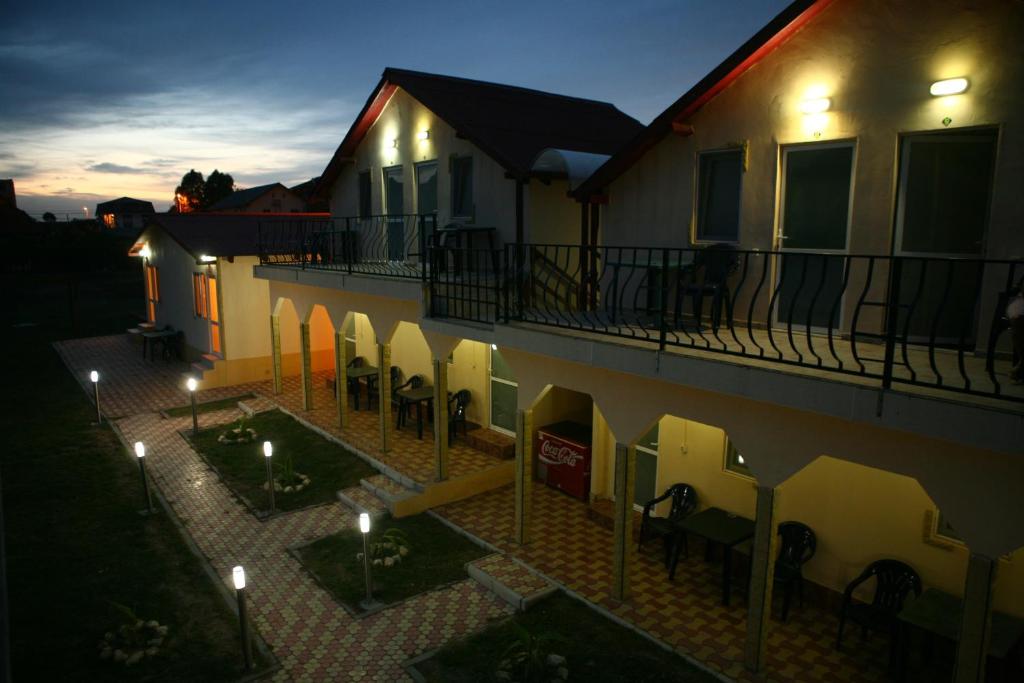 a building with a balcony with chairs and lights at Vile Mamaia Nord in Mamaia Sat/Năvodari