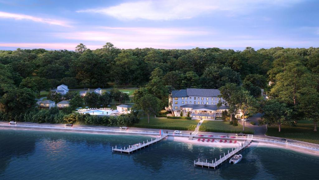 an aerial view of a house on the water with a dock at The Pridwin Hotel in Shelter Island