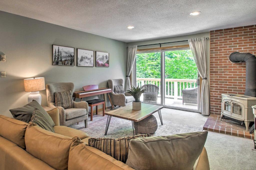 a living room with a couch and a fireplace at North Conway Condo in the White Mountains! in North Conway