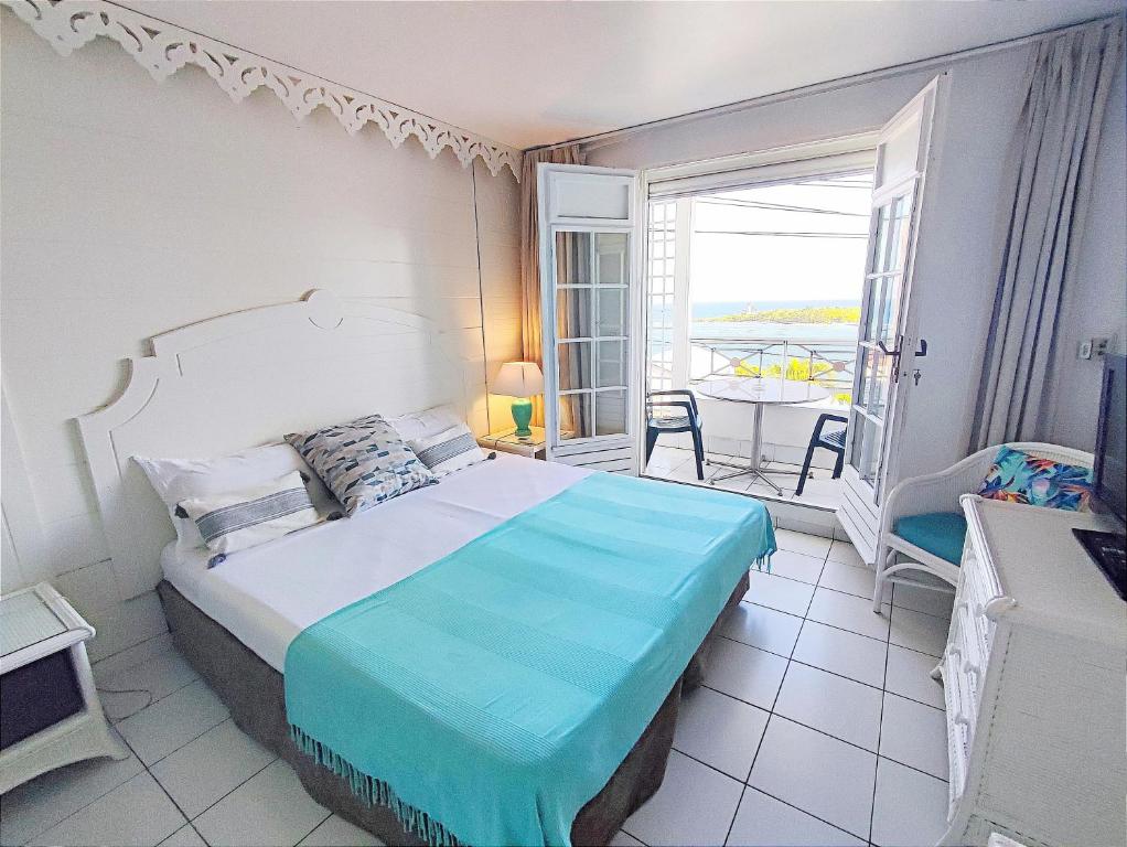 Ліжко або ліжка в номері Résidence Turquoise Guadeloupe - Vue mer et lagon