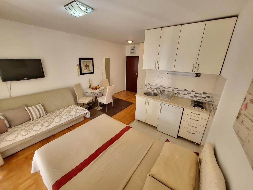 a living room with a couch and a table at Apartman Avanti in Budva