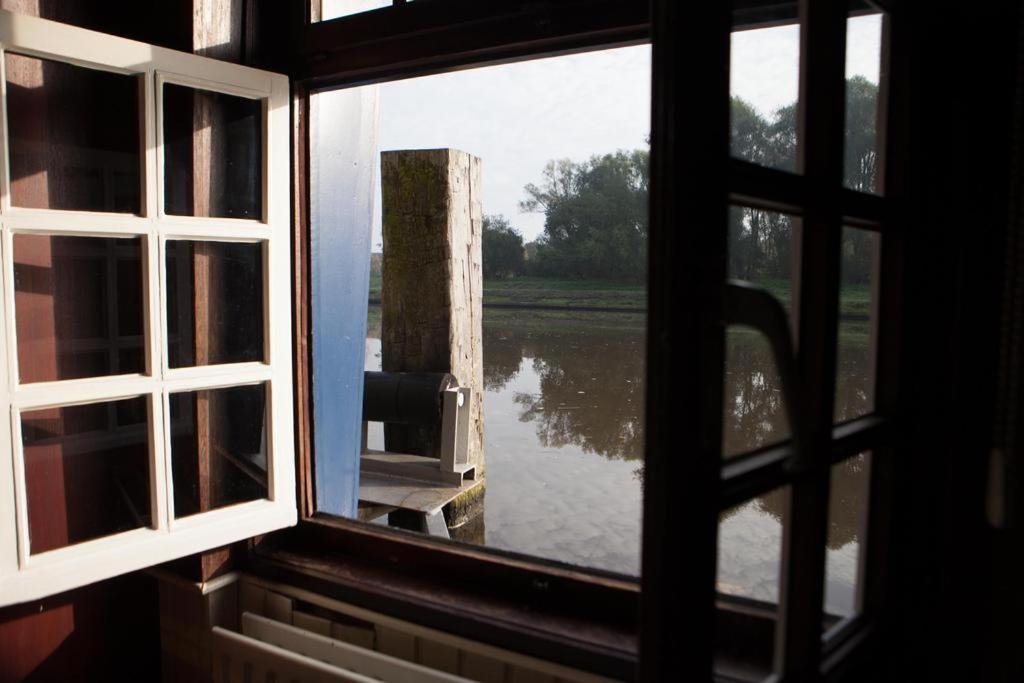 an open window with a view of a body of water at Boat Hotel De Barge in Bruges