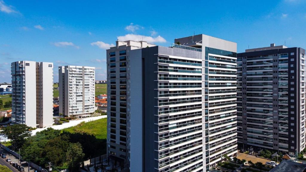 um grupo de edifícios altos em uma cidade em Condomínio Residencial Duo JK Sky - São José do Rio Preto em Sao Jose do Rio Preto