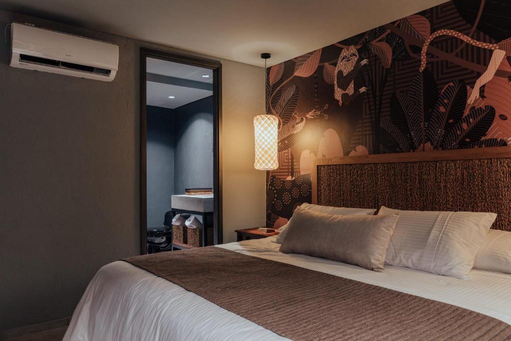 Postel nebo postele na pokoji v ubytování Sui Boutique Hotel
