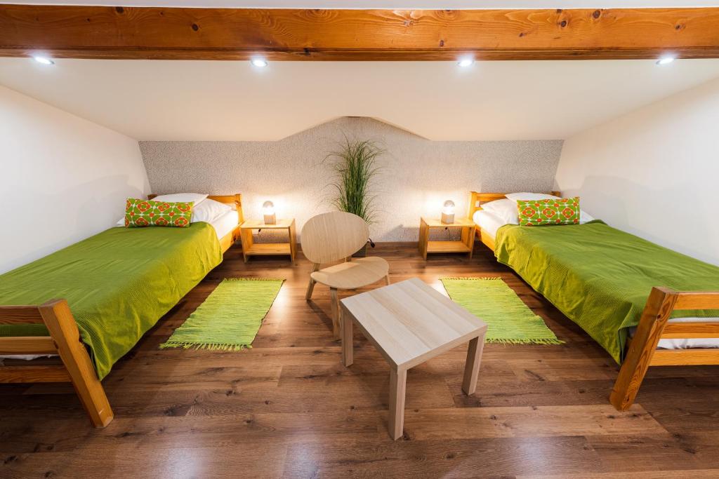 dwa łóżka w pokoju z zieloną pościelą w obiekcie Balaton View Apartment w mieście Balatonboglár