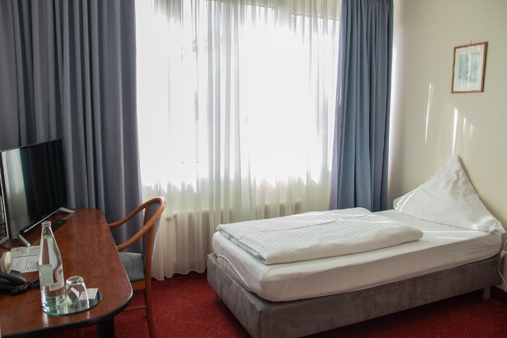 Postel nebo postele na pokoji v ubytování Hotel Alpha
