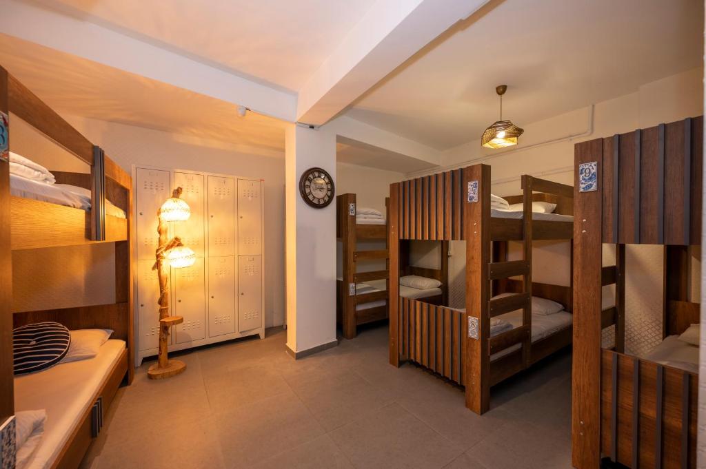 a room with several bunk beds and a clock at Taksim Square Hostel in Istanbul