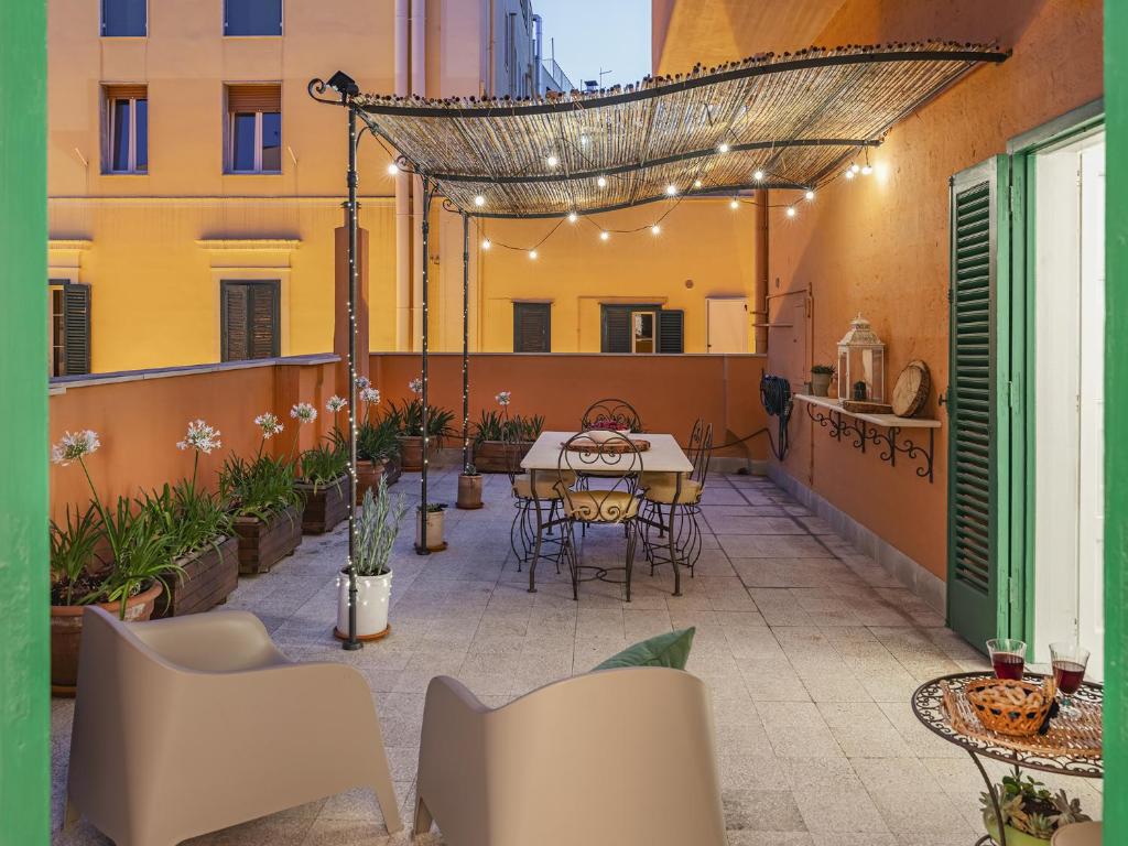 a patio with a table and chairs on a building at Agapanthus in Matera