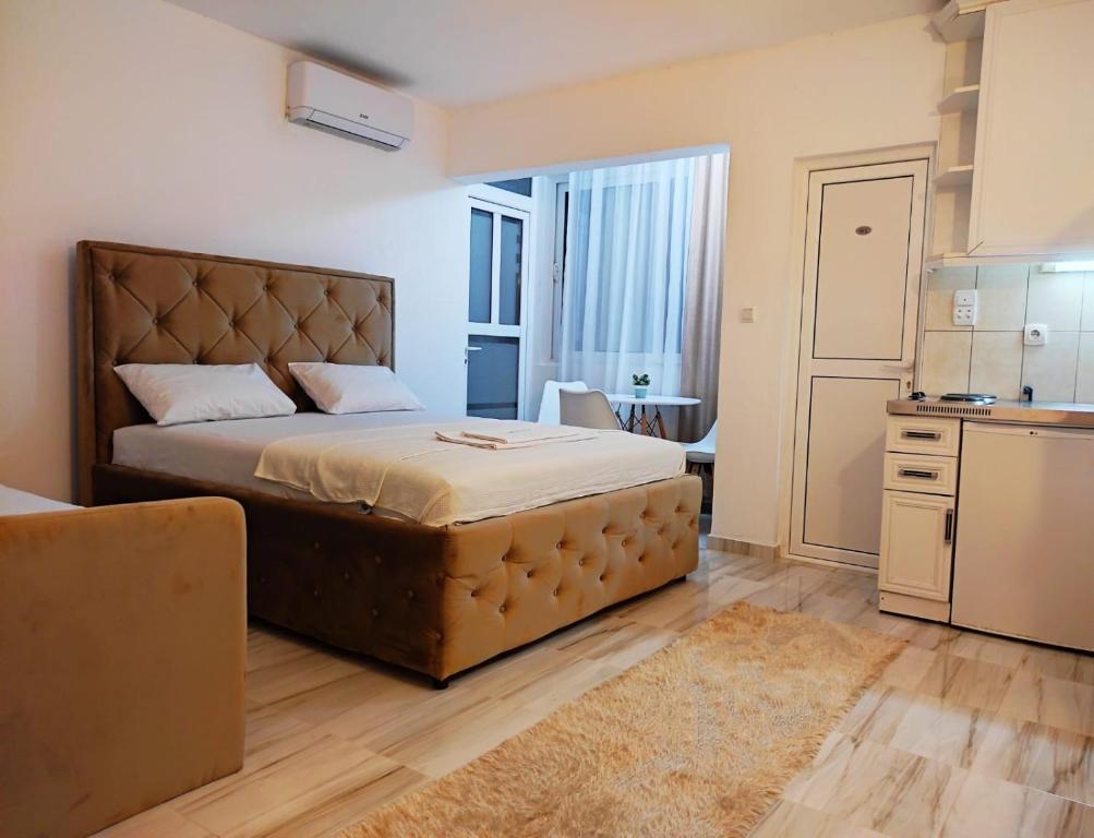a bedroom with a large bed in a room at Apartments FLORA and boat cruising in Virpazar