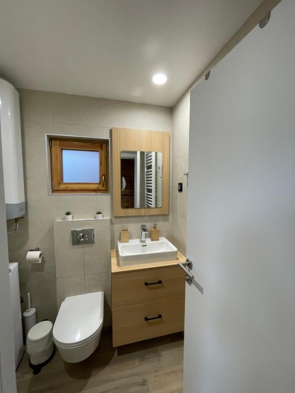 a bathroom with a white toilet and a sink at Mokrogorski konaci in Mokra Gora