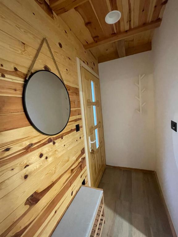 a room with a mirror on a wooden wall at Mokrogorski konaci in Mokra Gora