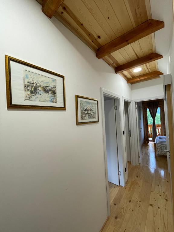 a room with two pictures on the walls of a house at Mokrogorski konaci in Mokra Gora
