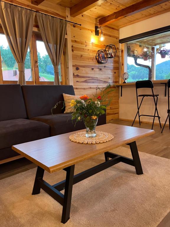 a living room with a coffee table and a couch at Mokrogorski konaci in Mokra Gora