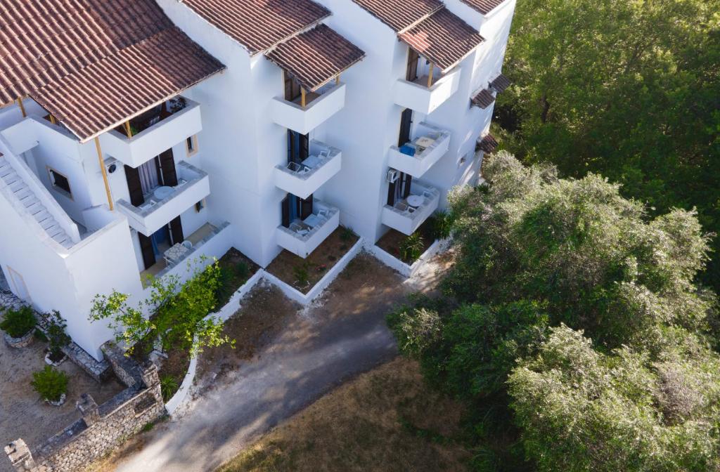 an overhead view of a white building with trees at Corfu Room in Áyioi Dhéka