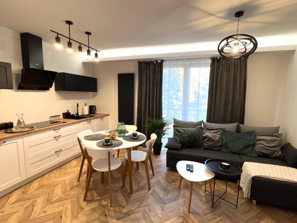 a living room with a couch and a table at Apartament Stylowy 2 in Leszno