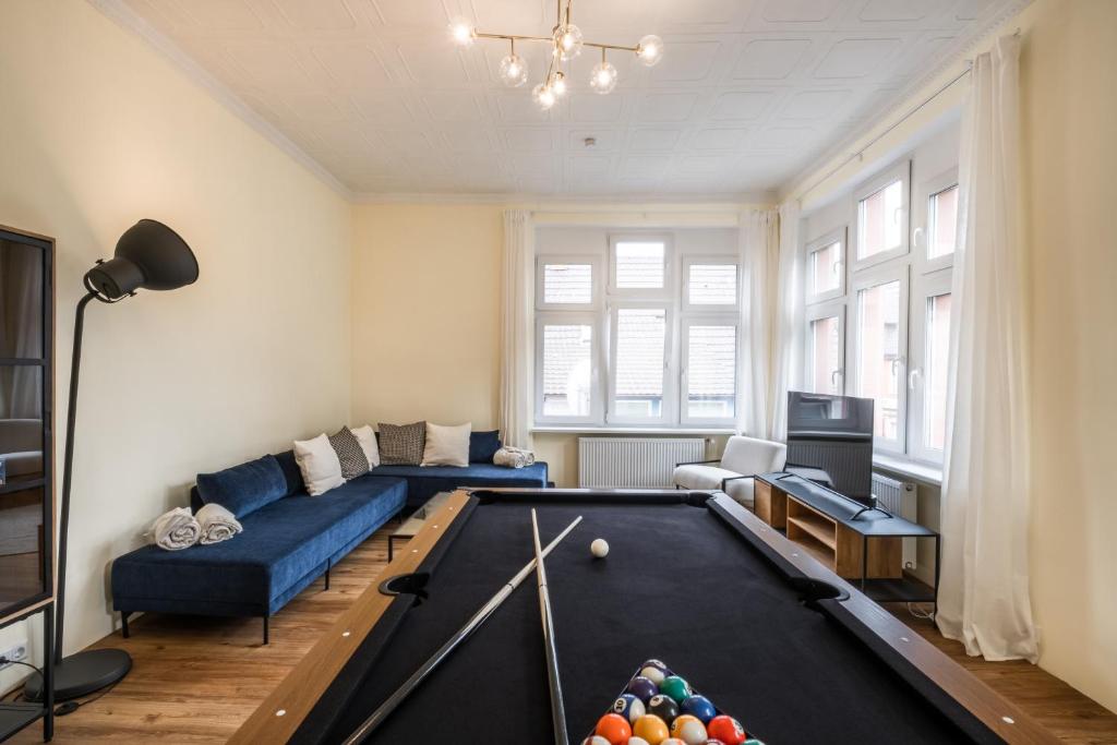 a living room with a pool table and a couch at Nähe Europa Park! Exklusive Ferienwohnung mit 140 qm! in Kippenheim
