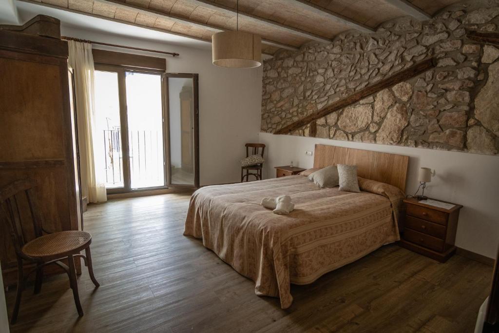 Ένα ή περισσότερα κρεβάτια σε δωμάτιο στο Casa Monferrer