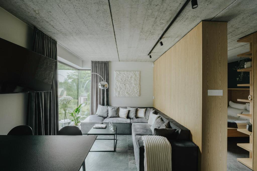 a living room with a couch and a table at Apartamenty HEYER in Łódź