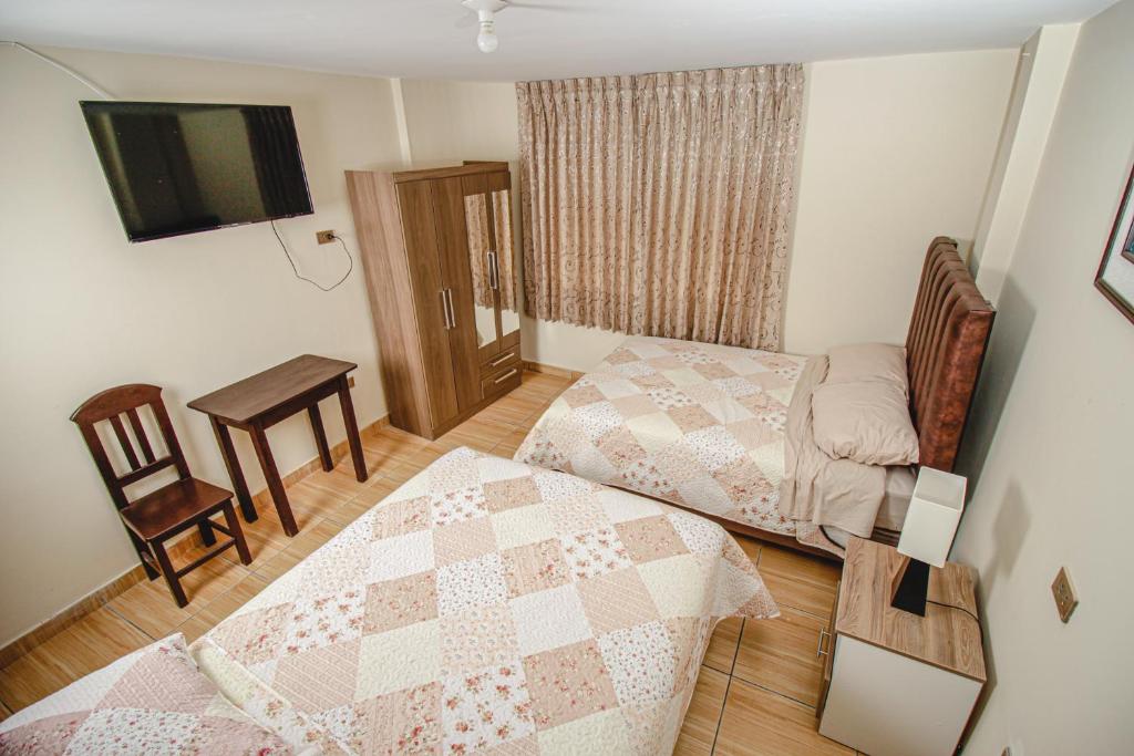 Postel nebo postele na pokoji v ubytování Antara Hostal