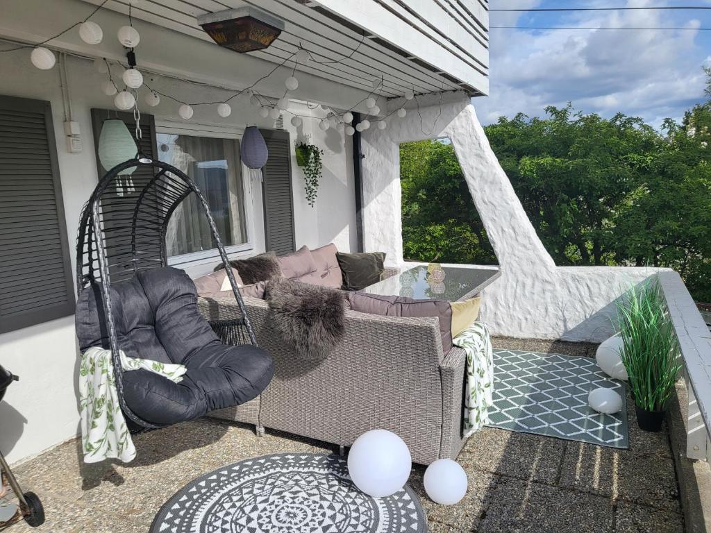 a porch with a couch and a swing at Bergen Apartment with Fjord View in Isdalsstø