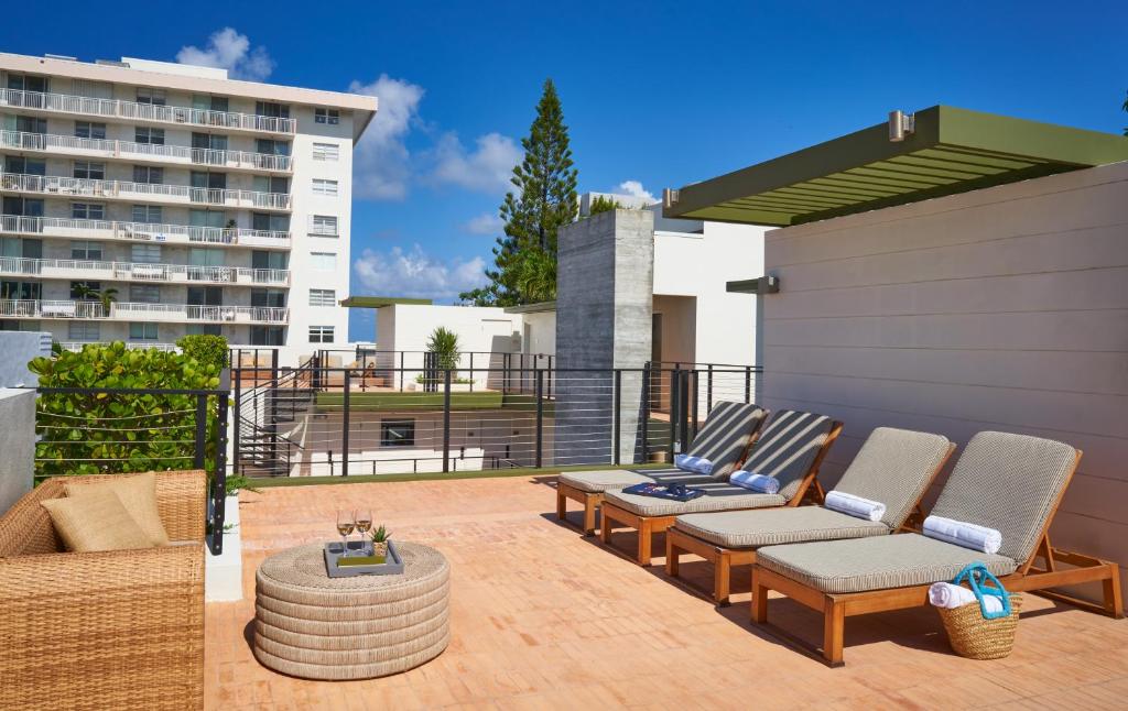 a patio with two chairs and a table at The Balfour Hotel in Miami Beach