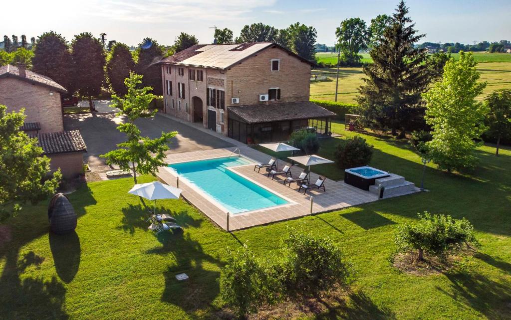 an aerial view of a house with a swimming pool at Casa delle Noci country house, pool & SPA in Modena