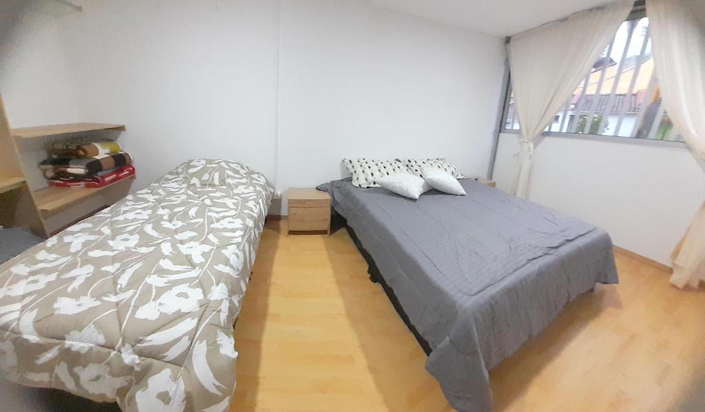 Postel nebo postele na pokoji v ubytování Casa Jaguar Manizales sector Cable