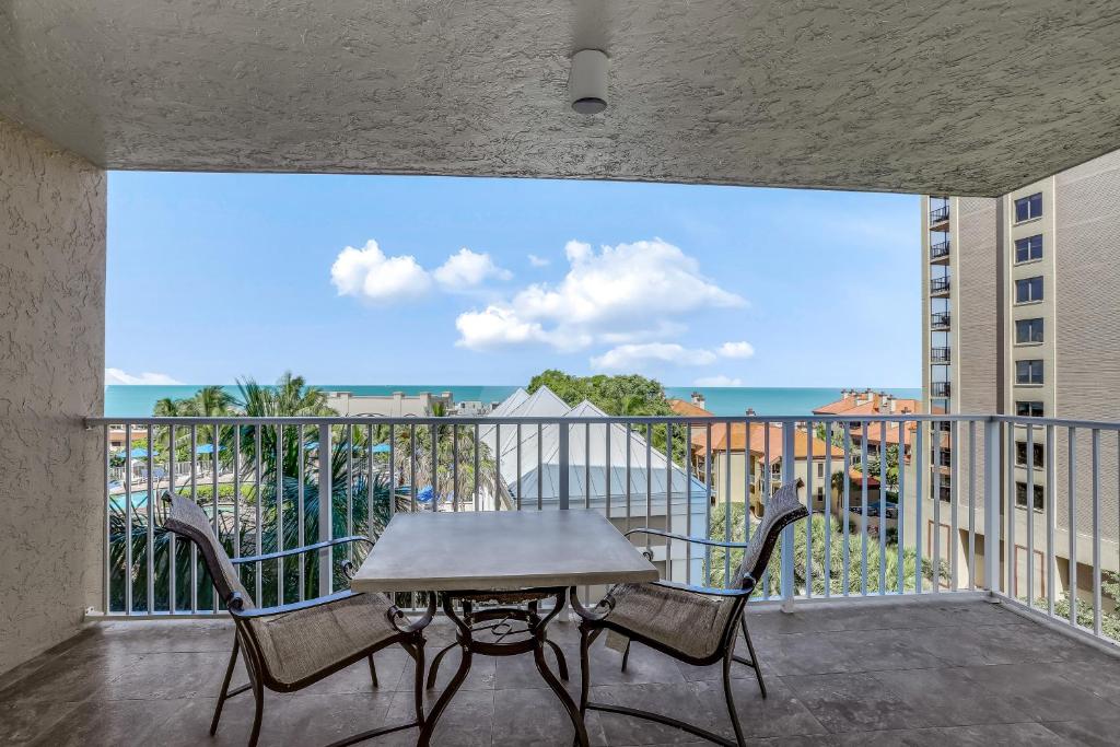 a table and chairs on a balcony with a view of the ocean at Marco Beach Ocean Resort IV in Marco Island