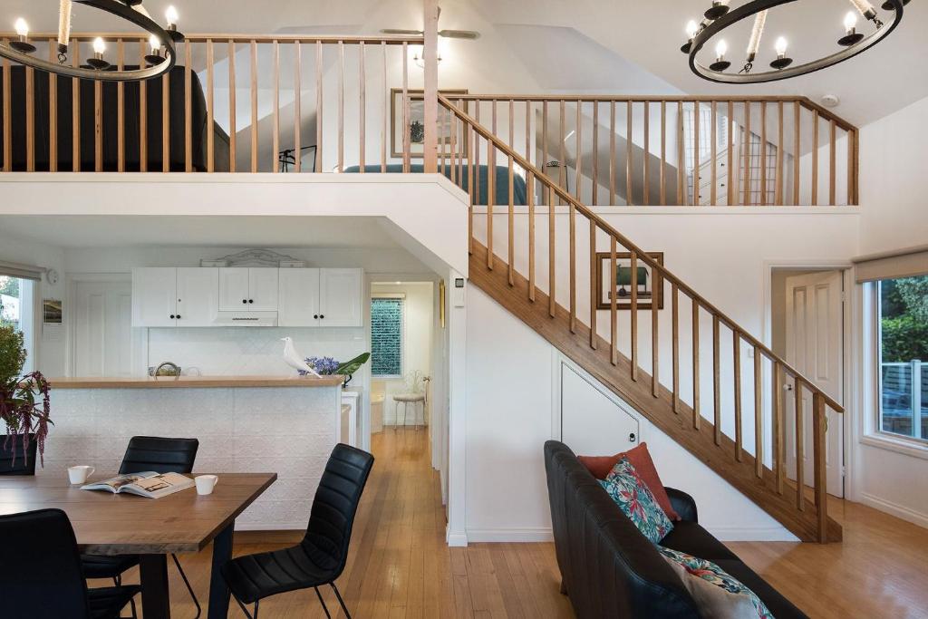 a kitchen and dining room with a staircase in a house at Aggies Way in Daylesford