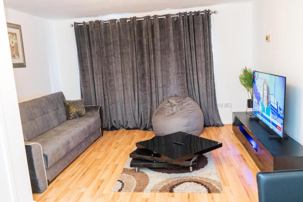 a living room with a couch and a coffee table at Vanville Homes in Manchester