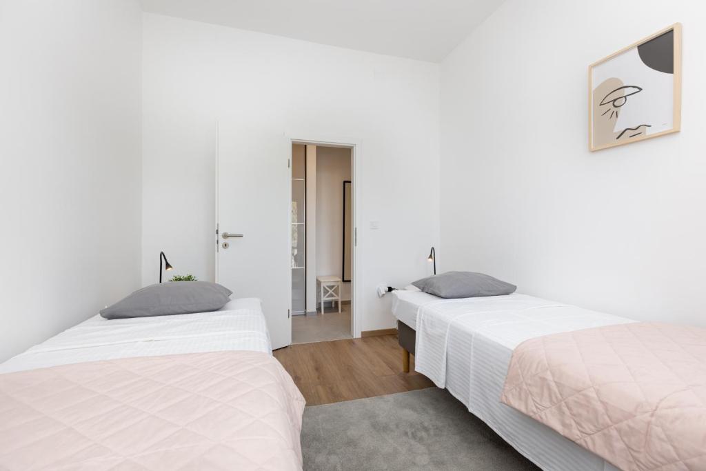 Postel nebo postele na pokoji v ubytování Apartments Cukar