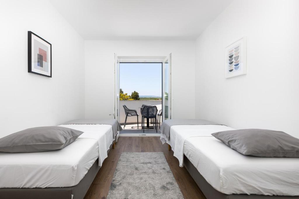 Postel nebo postele na pokoji v ubytování Apartments Cukar