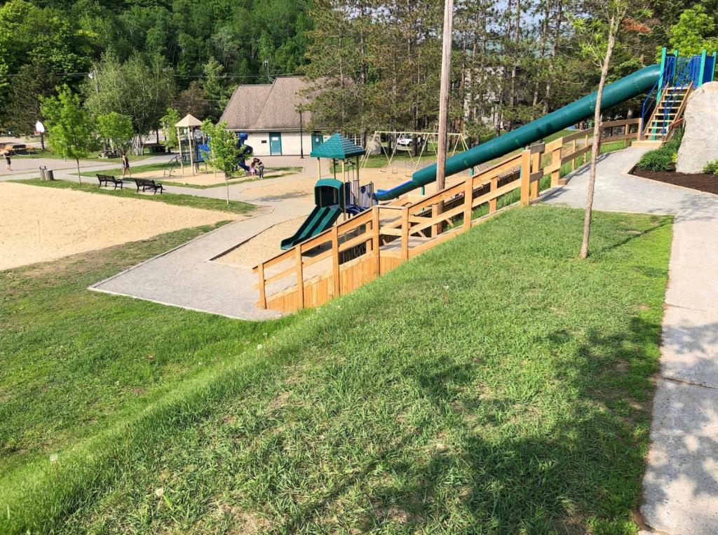 a playground with a slide in a park at Complexe LIVTremblant by Gestion ELITE - LIV6 in Mont-Tremblant