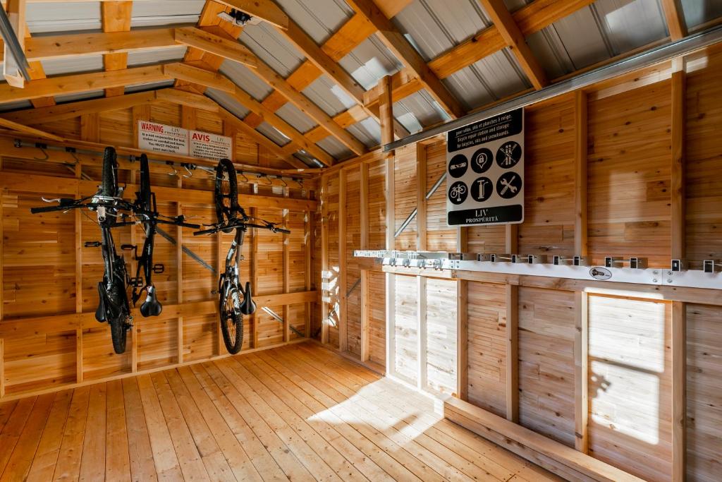 a cabin with wooden walls and a room with a motorcycle at Complexe LIVTremblant by Gestion ELITE - LIV6 in Mont-Tremblant