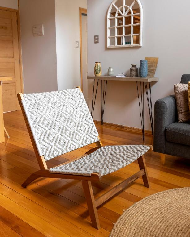 a wooden chair sitting in a living room at Cabañas Arrayanes de Huillinco en Chiloé in Chonchi