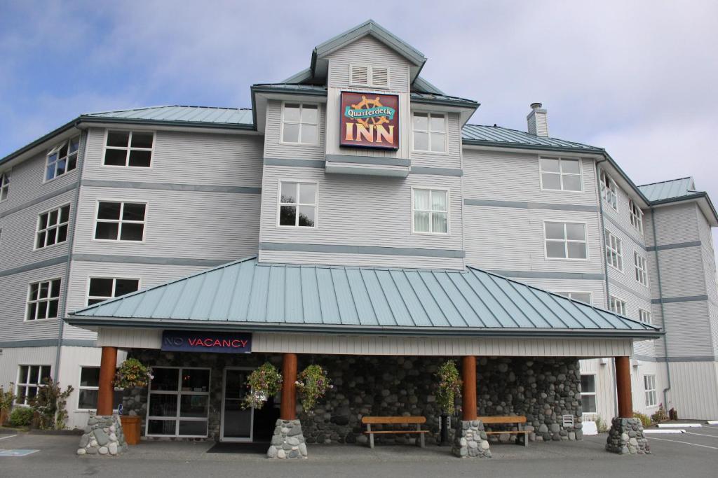 a inn with a sign on the front of it at Quarterdeck Inn Port Hardy in Port Hardy