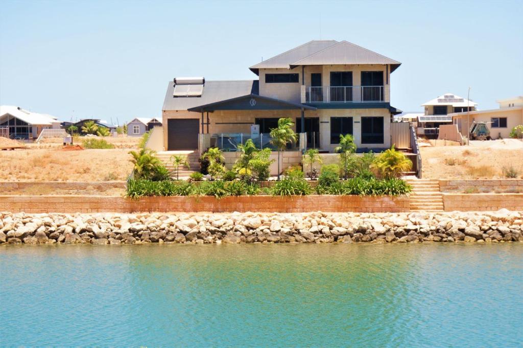 a house on the shore of a body of water at 27 Corella Court in Exmouth