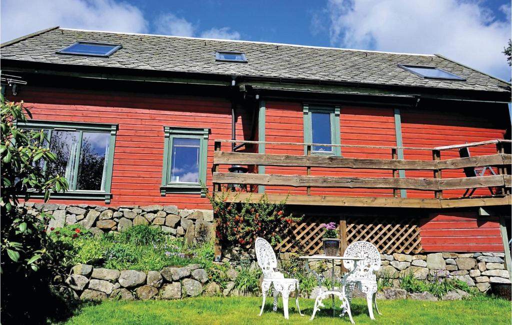 two chairs and a table in front of a house at 2 Bedroom Amazing Apartment In Sandnes in Bråstein