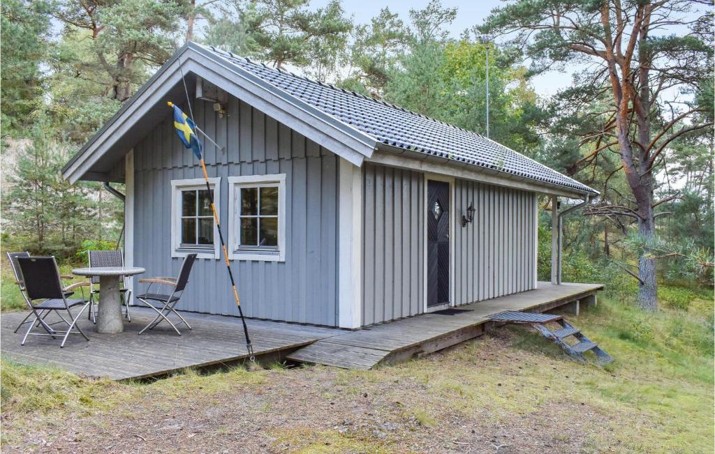 a small shed with a table and chairs on a deck at 2 Bedroom Stunning Home In Yngsj in Yngsjö