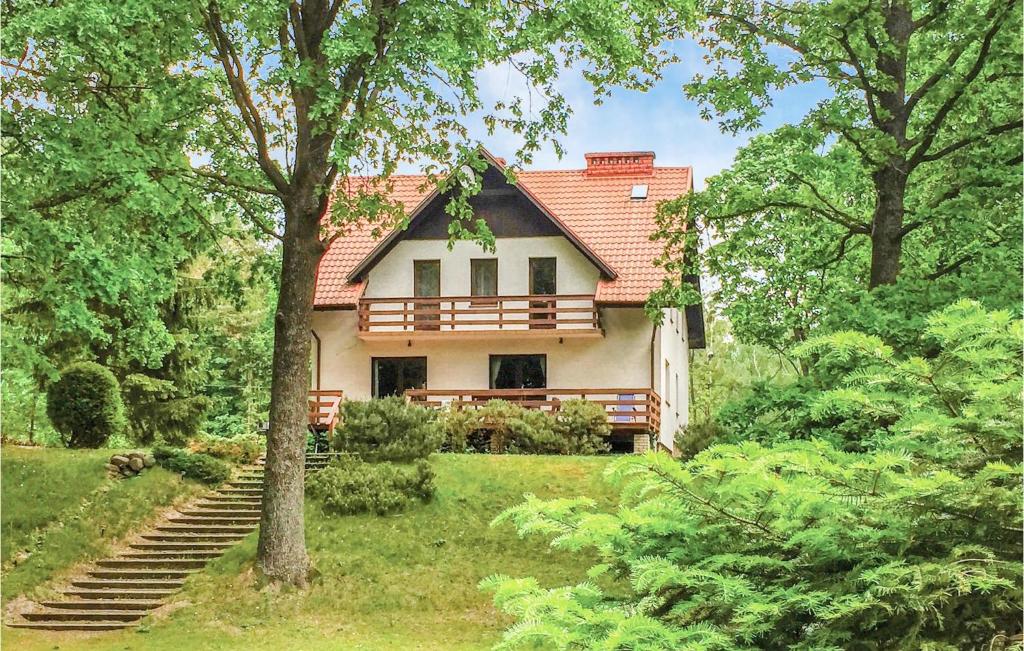 a house with a porch and stairs in the yard at Beautiful Home In Swietajno With 5 Bedrooms, Sauna And Wifi in Świętajno