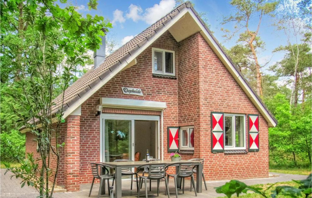 a brick house with a table in front of it at Dopheide in Ommen