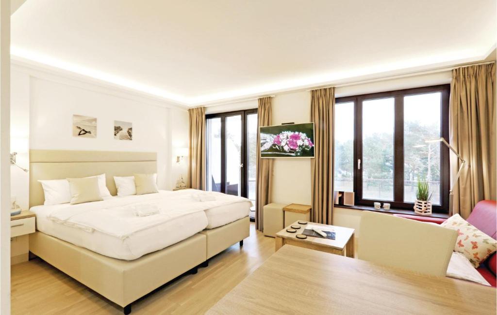 a bedroom with a large bed and a living room at Angel in Binz