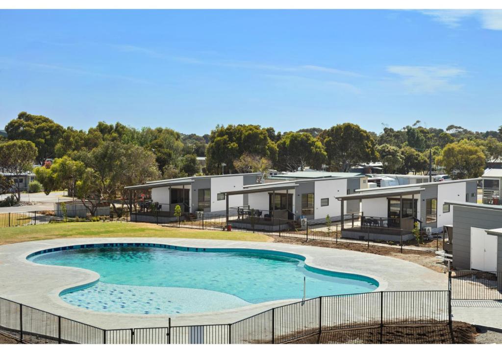 a large swimming pool in front of houses at Discovery Parks - Goolwa in Goolwa